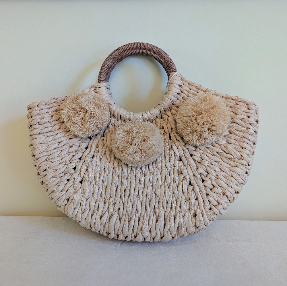 Chic Pink Woven Handbag with Pom Poms